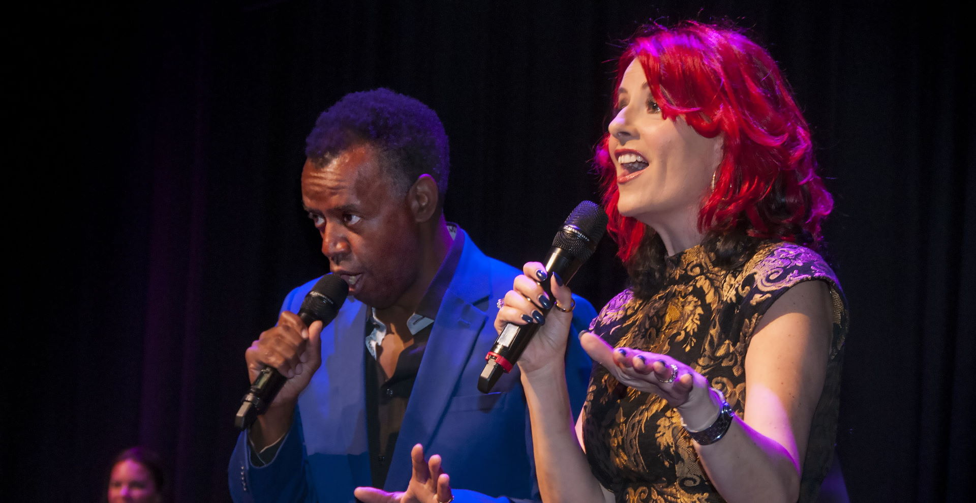 Carrie and David Grant presenting on a stage